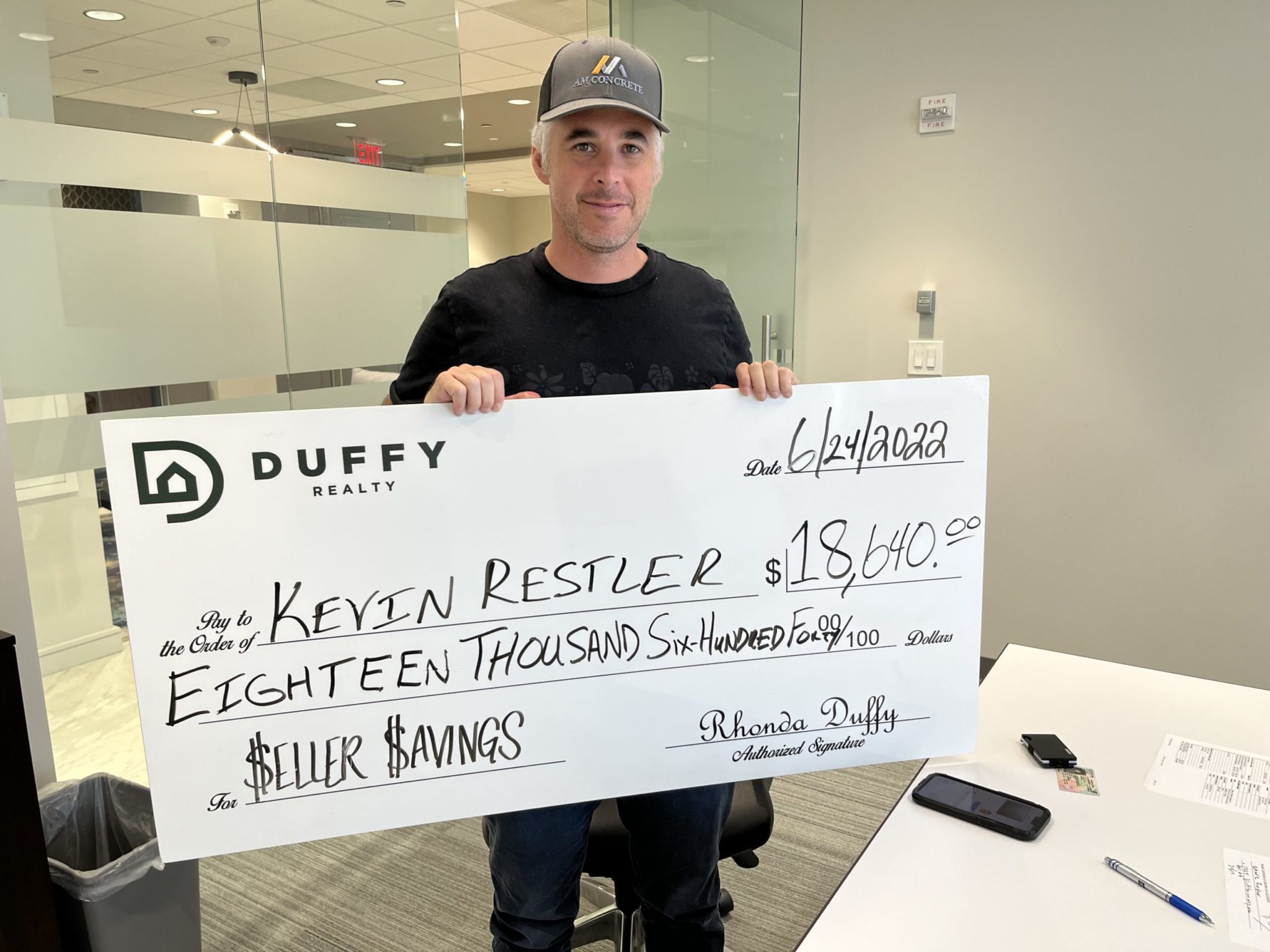 DUFFY seller holding an $18,640 seller-savings check